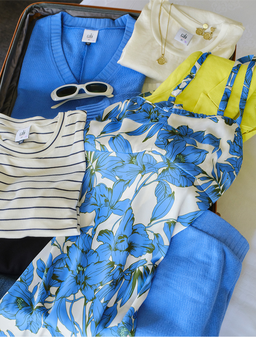 clothing arranged on a bed, ready to be packed